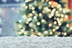 Empty white snow with blur Christmas tree with bokeh light background photo