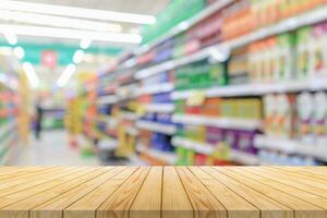 Empty wood table top with supermarket blurred background for product display photo