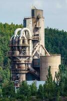 Cement factory, quarry with silos and industrial equipment. Limestone mining for cement production. photo