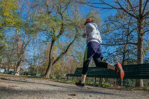 Girl running in the park to maintain fitness photo