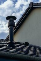 Chimney of a wood or pellet stove installed on the roof photo