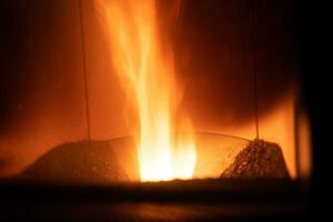 Hearth of a pellet stove, granules stove with flames photo