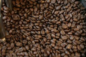 Coffee beans in a coffee grinder. Coffee beans background photo