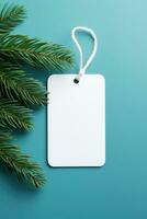 AI generated White blank price tag on blue background with Christmas tree branch. Copy space. photo