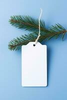 AI generated White blank price tag on blue background with Christmas tree branch. Copy space. photo