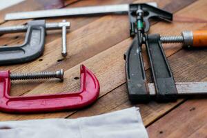 Collection of woodworking tools on a wooden background. photo