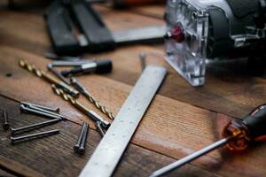 Collection of woodworking tools on a wooden background. photo