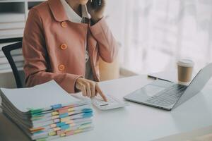 Audit concept,Administrator business man financial inspector and secretary making report calculating balance. Internal Revenue Service checking document. photo