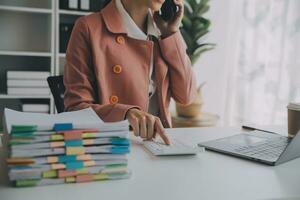 Audit concept,Administrator business man financial inspector and secretary making report calculating balance. Internal Revenue Service checking document. photo