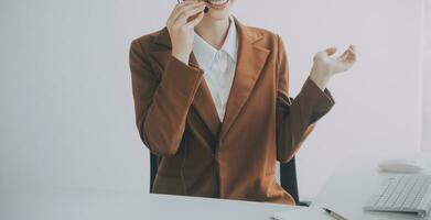 Beautiful female call center operator working on computer in office photo