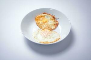 Fried egg with bread on white background. Thai style breakfast. photo