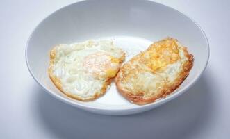 Fried egg with bread on white background. Thai style breakfast. photo