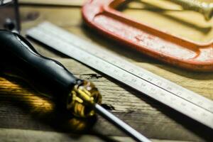 Collection of woodworking tools on a wooden background. photo