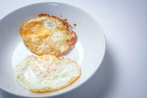 Fried egg with bread on white background. Thai style breakfast. photo