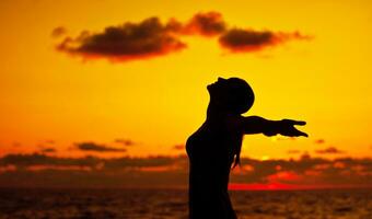 Woman silhouette over sunset photo