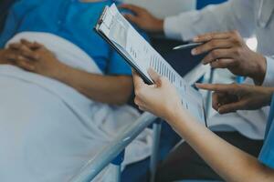 Women Asian doctors hold the patient hand and encourage and provide medical advice While checking the patient health in bed. Concept of Care and compassion, antenatal care, Threatened abortion photo