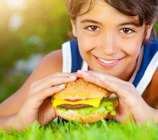 Happy boy eating burger photo