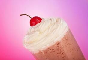 Tasty milkshake over pink background photo