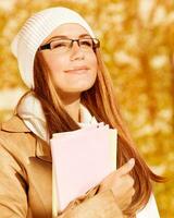 Portrait of student girl in autumn photo