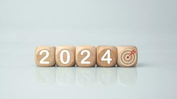 Wooden blocks lined up with the letters 2024. Represents the goal setting for 2024, the concept of a start. financial planning development strategy business goal setting photo