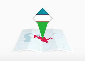 Uzbekistan is depicted on a folded paper map and pinned location marker with flag of Uzbekistan. vector