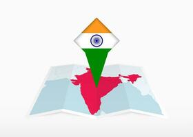 India is depicted on a folded paper map and pinned location marker with flag of India. vector