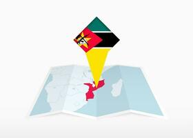 Mozambique es representado en un doblada papel mapa y clavado ubicación marcador con bandera de Mozambique. vector