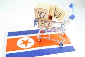 Online shopping, Shopping cart box on North Korea flag, import export, finance commerce. photo