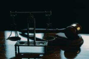 Justice and law concept.Male judge in a courtroom with the gavel, working with, computer and docking keyboard, eyeglasses, on table in morning light photo