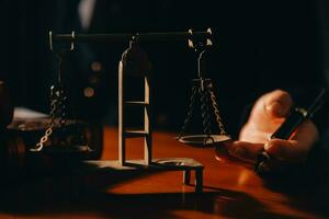 Business and lawyers discussing contract papers with brass scale on desk in office. Law, legal services, advice, justice and law concept picture with film grain effect photo