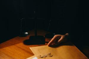 Business and lawyers discussing contract papers with brass scale on desk in office. Law, legal services, advice, justice and law concept picture with film grain effect photo