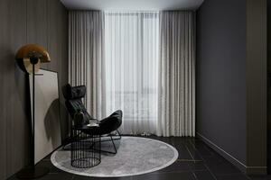 An empty space used for reading and relaxing, with an interior black chair, and a stand lamp near the window. photo