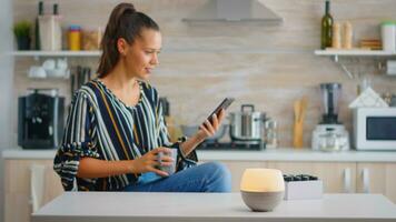 Woman enjoying aromatherapy with essential oils diffuser working while she drinks coffe. Aroma health essence, welness aromatherapy home spa fragrance tranquil theraphy, therapeutic steam, mental health treatment photo