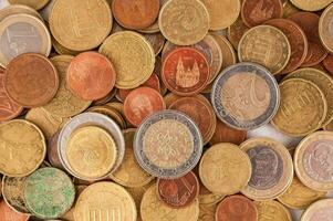 a pile of coins on a white background photo