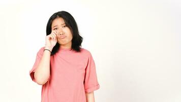 Young Asian woman in pink t-shirt doing cry sad face expression isolated on white background photo