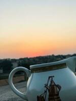 two white and brown jugs with designs on them photo