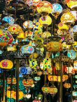 many colorful lamps are hanging from the ceiling photo