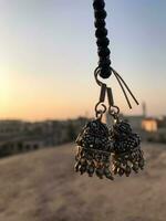 a pair of earrings hanging from a rope photo