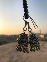 a pair of earrings hanging from a rope photo