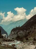 a river runs through a valley surrounded by mountains photo