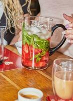 refrescante sandía y menta bebida en lanzador con hielo y vaso foto