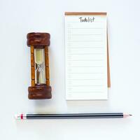 Time management concept, to do list with notepad and black pencil on white desk. photo