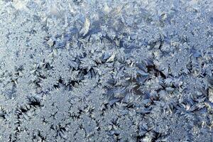 frosty patterns on the window frosty background Ice on a window photo