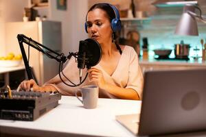 Influencer wearing headphones recording new podcast series for her audience. On-air online production internet broadcast show host streaming live content, recording digital social media communication photo