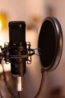 Microphone for podcast of famous influencer in home studio ready for recording. Logging social media content with production microphone. Digital web internet streaming station photo