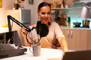 Famous woman holding professional microphone while recording podcast for social media. On-air online production internet broadcast show host streaming live content, recording digital social media. photo