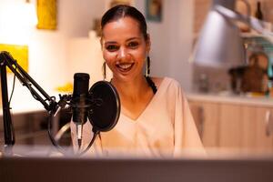 Presenter recording voice in home studio for media using professional microphone. Creative online show influencer On-air online production internet broadcast show host streaming live content recording photo