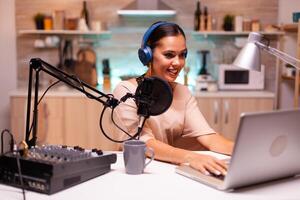 Video blogger reading email and wearing headphones during broadcast. Creative online show On-air production internet broadcast host streaming live content, recording digital social media communication photo