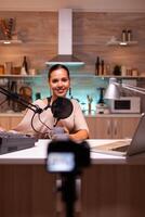 Vlogger on air during her online show using mixer and professional microphone. Online show production internet broadcast host streaming live content, recording digital social media communication photo