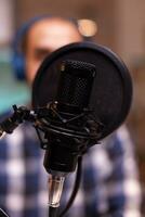 Close up of man speaking at broadcasting microphone. Creative online show On-air production internet broadcast host streaming live content, recording digital social media communication photo